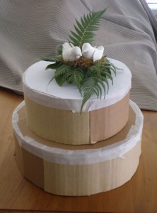 Bird cake topper on cardboard cake